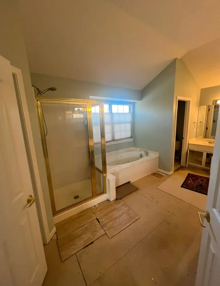 Primary bathroom with brass-framed shower and drop-in jetted tub before remodel, Twinsburg, Ohio