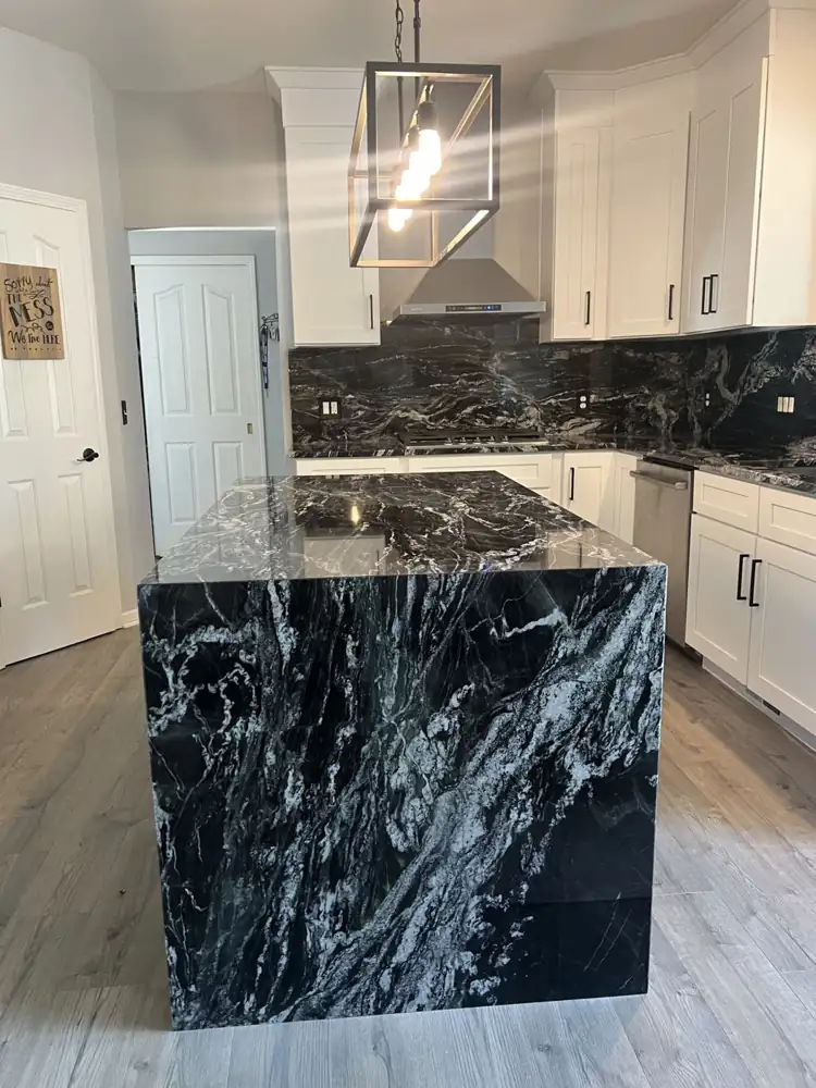 White shaker kitchen with black granite waterfall island and wall ovens, Twinsburg