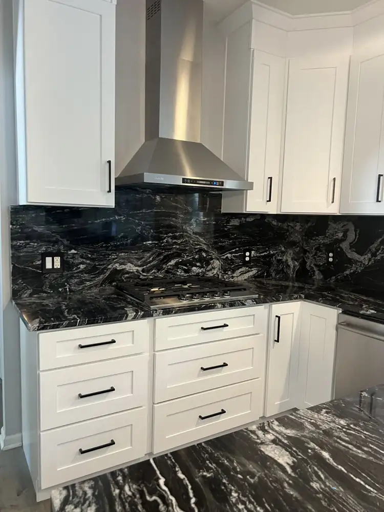 Another view: White shaker kitchen with black granite waterfall island, full-height granite backsplash and stainless hood, Twinsburg, Ohio